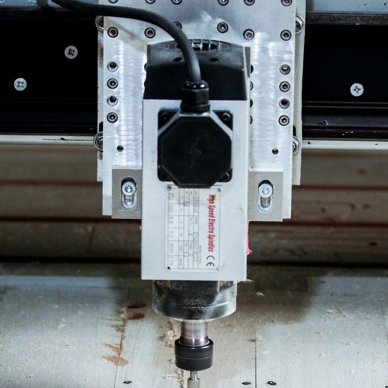 CNC engraving machine spindle cutting a wood panel — VPOINT TOOL